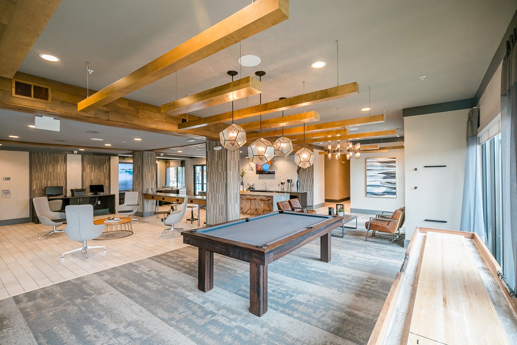 a spacious game room with a pool table
