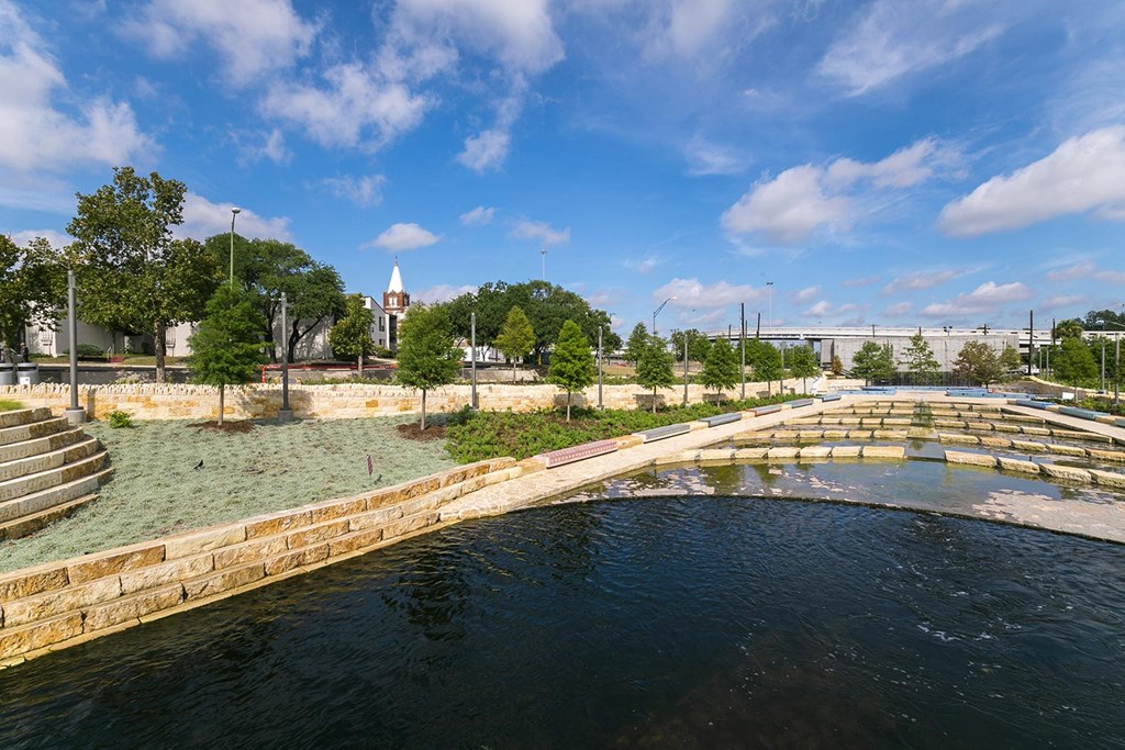 a bridge over a body of water with trees in the background
