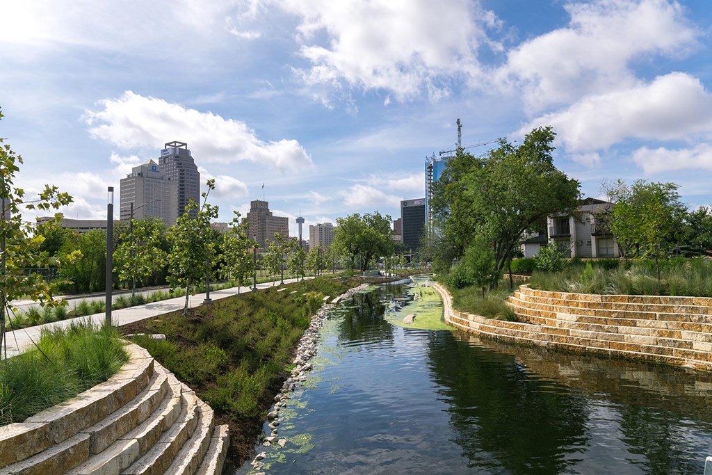 a river runs through a city with tall buildings in the background