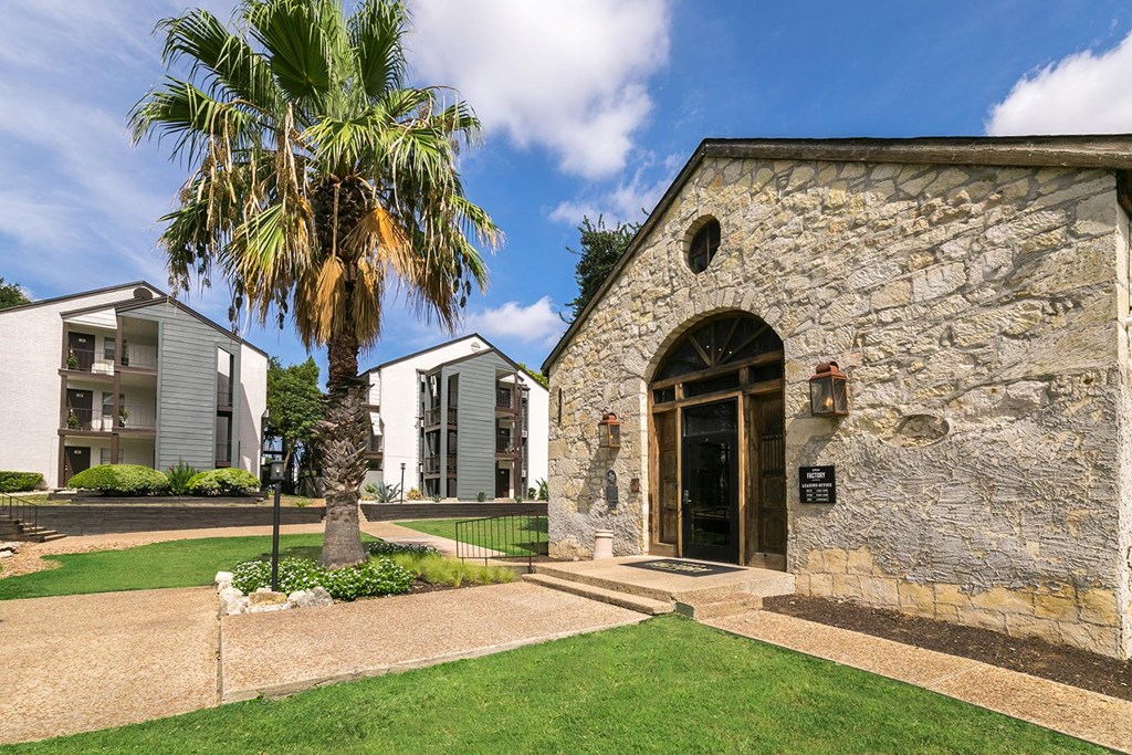 a stone building with a palm tree in front of it