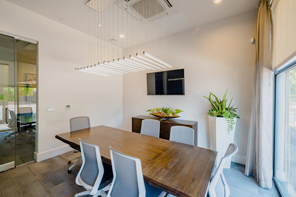 a dining room with a wooden table and white chairs