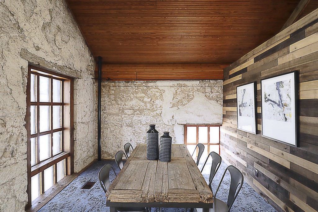 a dining room with a wooden table and chairs