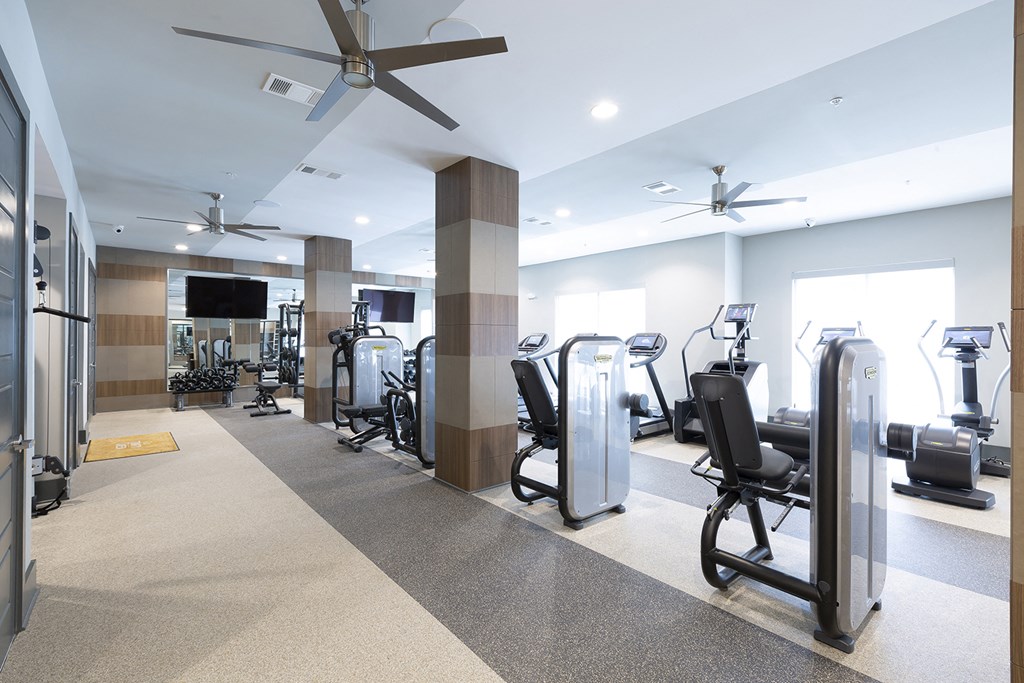 a gym with cardio machines and other exercise equipment
