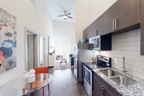 A kitchen with a table and chairs in the middle of the room.