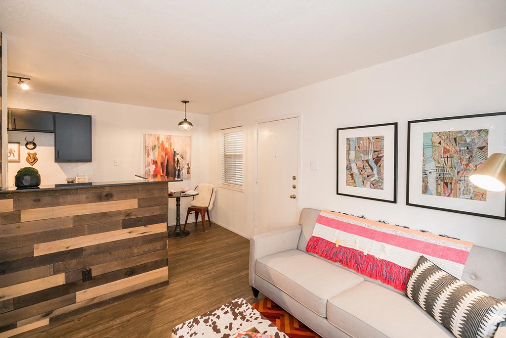 a living room with a couch and a desk with a chair