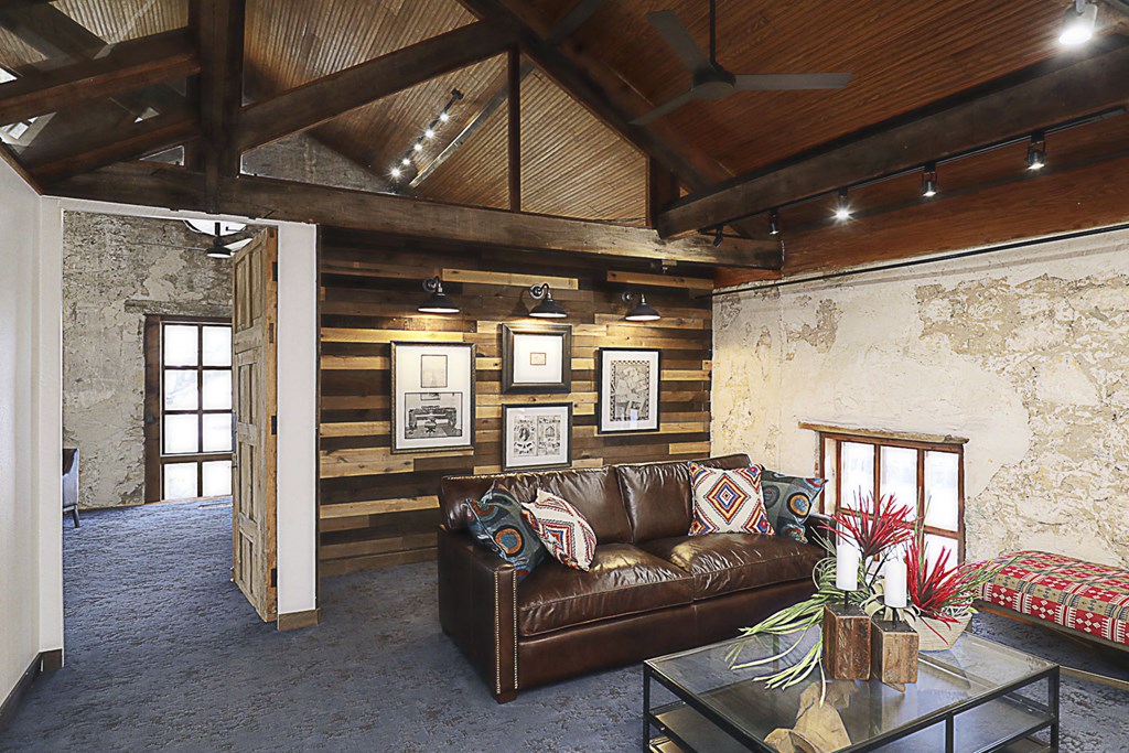 a living room with a leather couch and coffee table