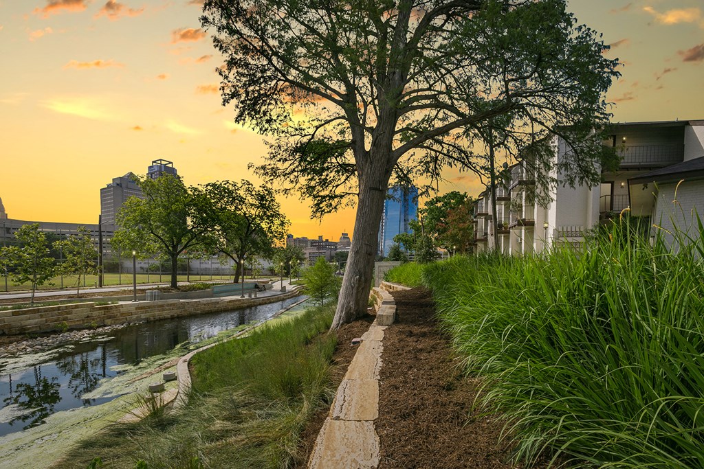 a view of the sacramento river at sunset with buildings in the background