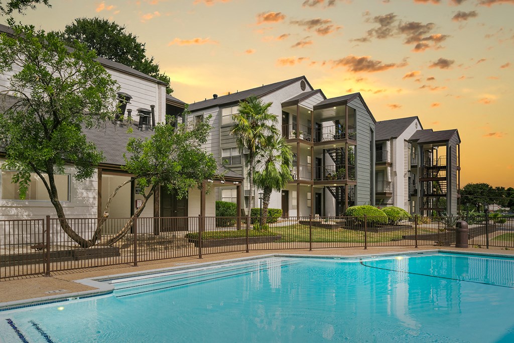 a large swimming pool in front of a building