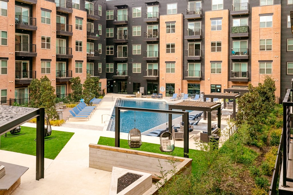 a swimming pool in front of an apartment building