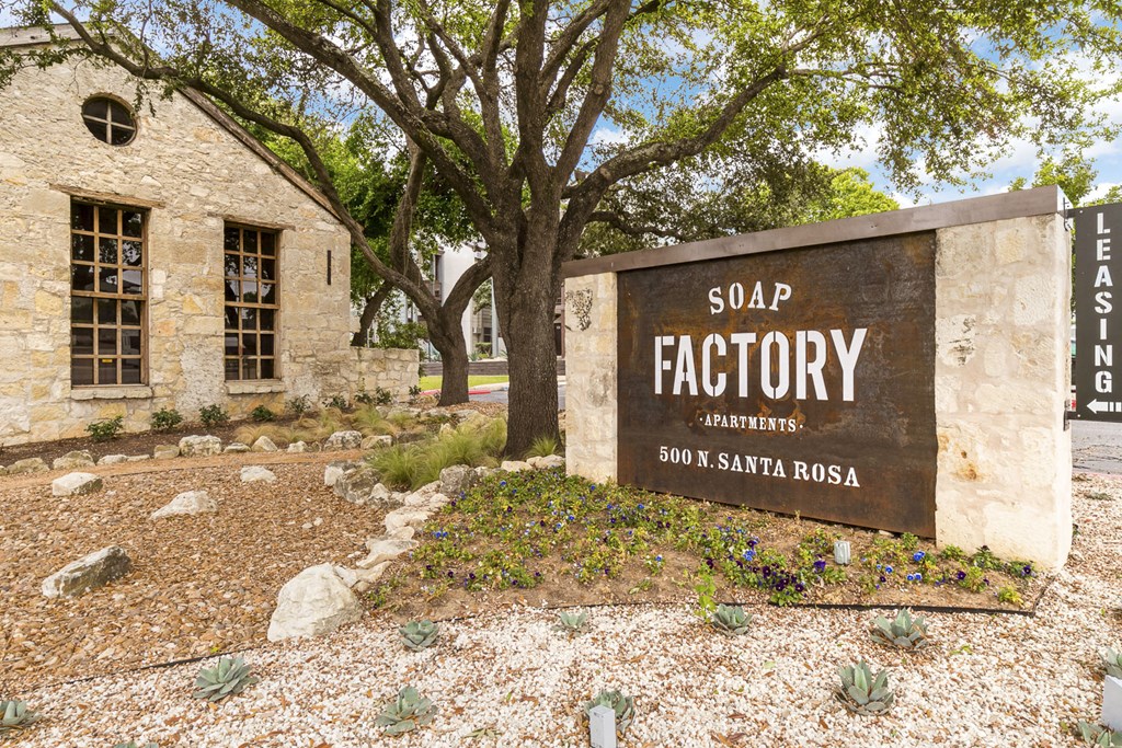 a stone building with a sign that says soap factory apartments