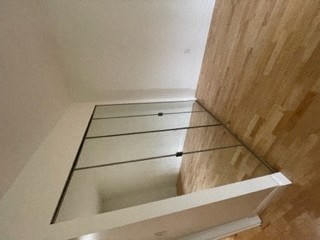 a bath room with a glass floor and a sink