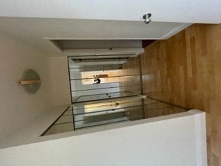 an empty room with a glass oven and wooden walls