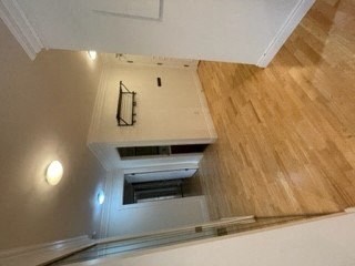 a view of a room from the top of a stairs