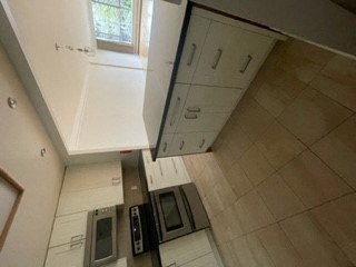 an overhead view of a kitchen with white cabinets