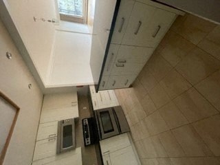 an overhead view of a kitchen with a microwave and a sink