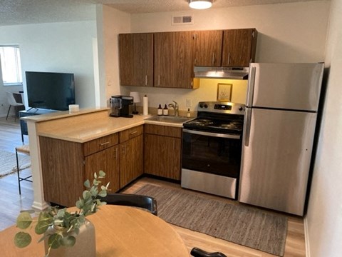 a kitchen with stainless steel appliances and wooden cabinets