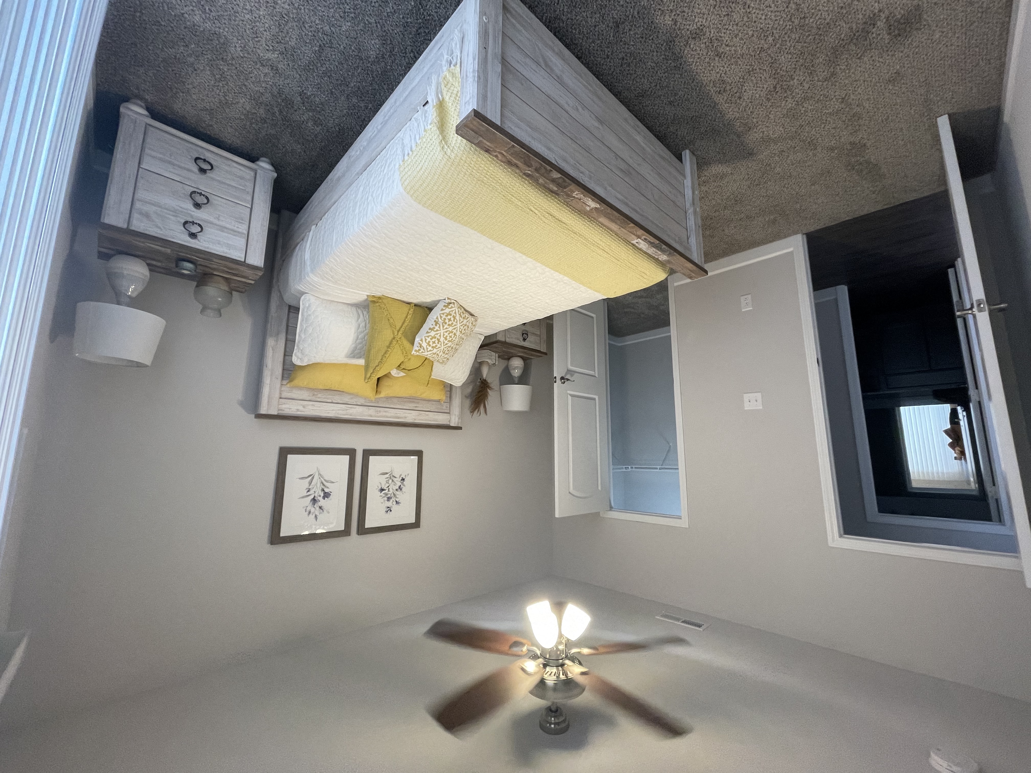 a bedroom with a bed and a ceiling fan