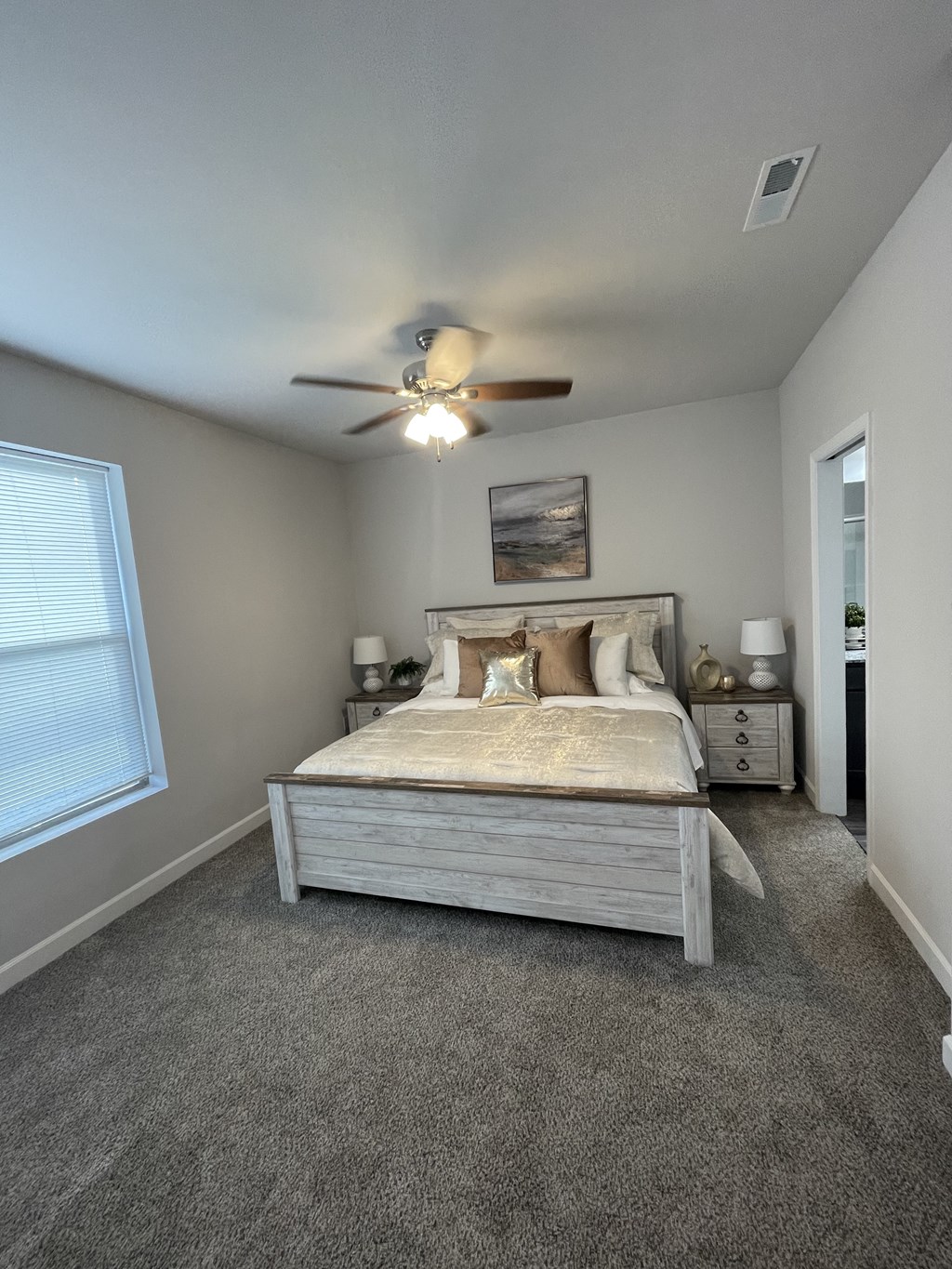 a bedroom with a bed and a ceiling fan