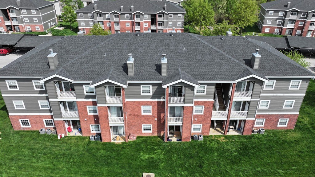 Apartment complex with grey and red buildings.