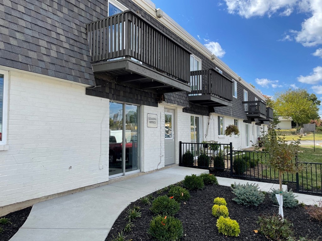 the front of a house with a porch and a balcony