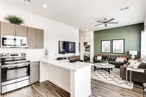 an open kitchen and living room with a couch and a table