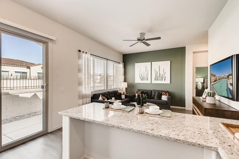 a kitchen with a counter and a living room