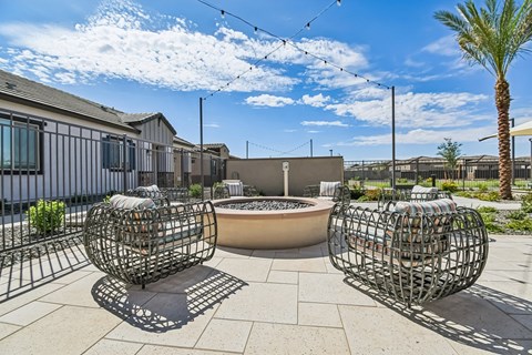 A patio area with two spherical metal structures and a hot tub.