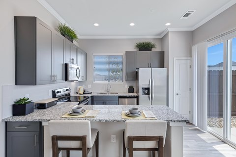 A modern kitchen with a dining table and chairs.