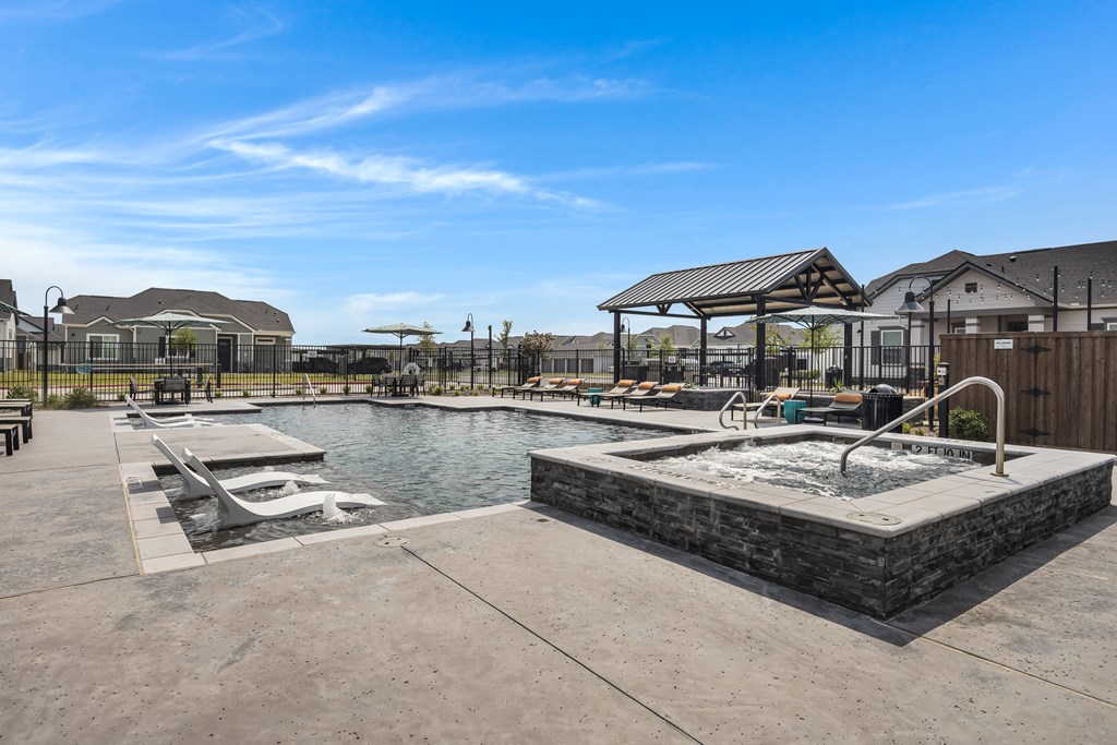 Resort-style pool, spa, and lounging at Avilla Oakridge in Forney, TX.