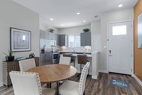 a kitchen and dining room with a table and chairs