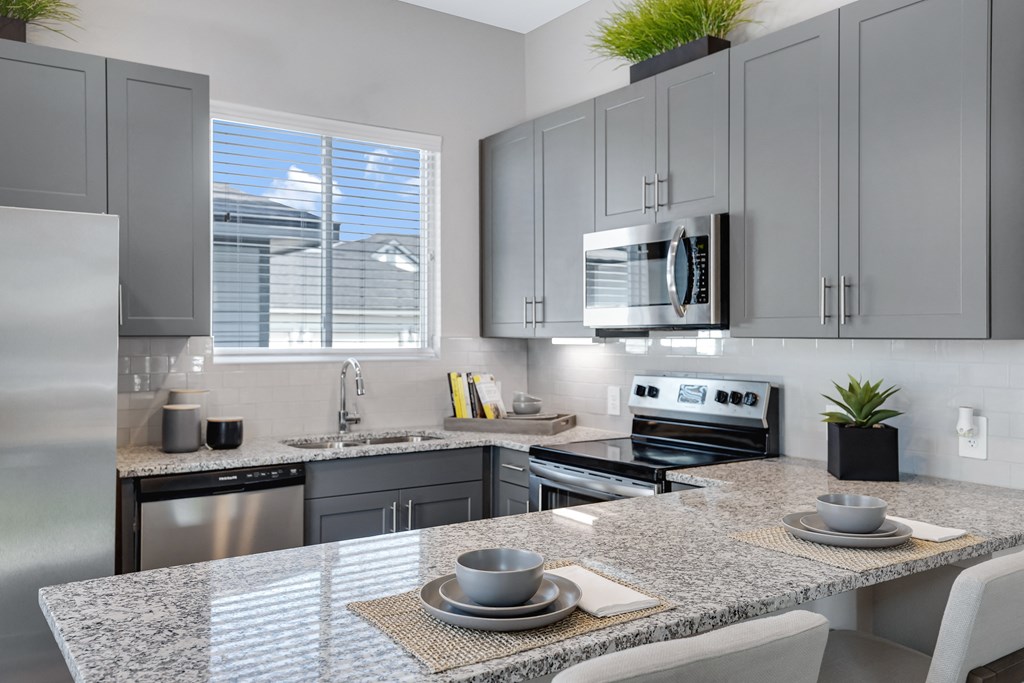 Gourmet Kitchen with Island Gourmet Kitchen with Island at Avilla Traditions, Grand Prairie, TX 75052