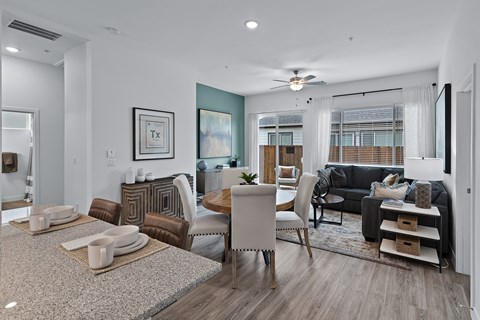 an open living room and dining room area with a table and chairs