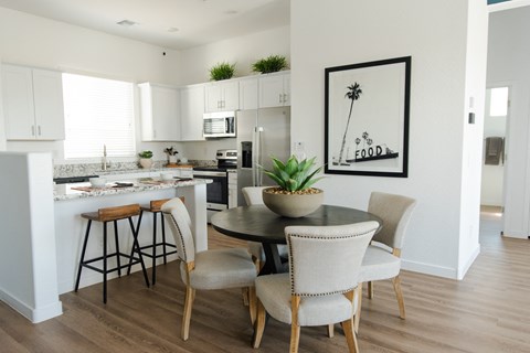 a kitchen and dining room with a table and chairs