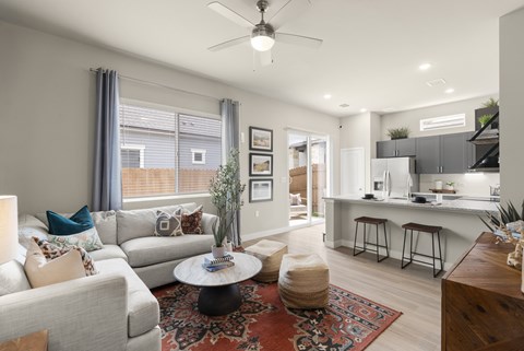A living room with a grey couch and a coffee table.