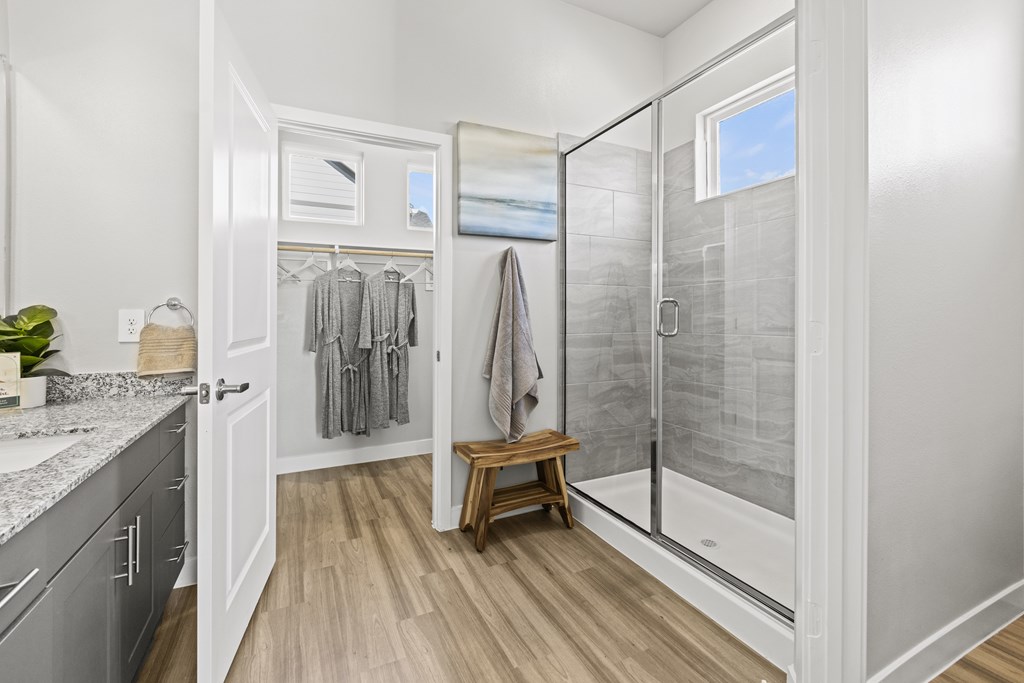 Primary bathroom with spacious walk-in closet and premium finishes at Avilla Lakeridge in Arlington 75002.