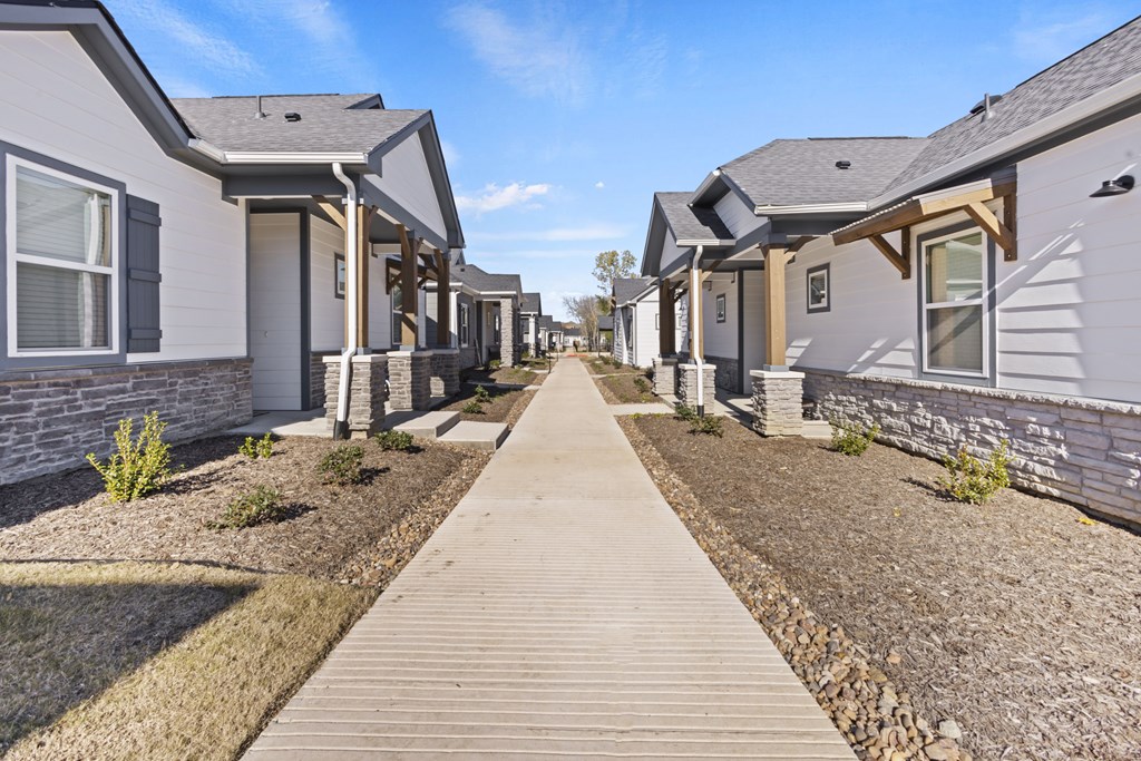 A row of houses with a wooden walkway in the foreground.