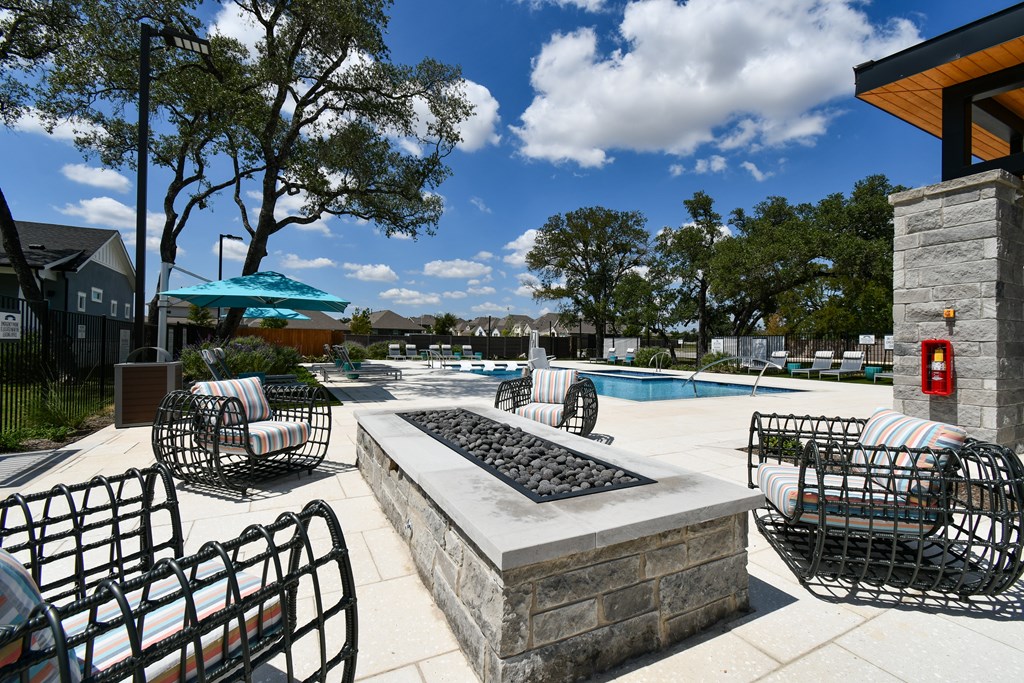 A pool area with a stone fountain in the center.