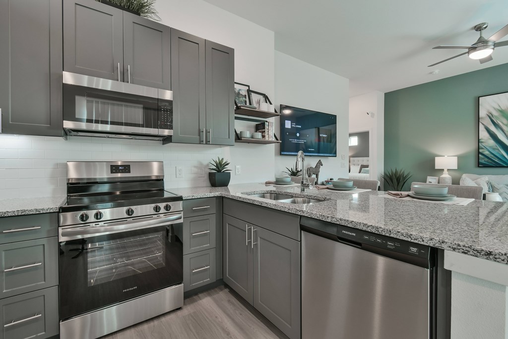 A modern kitchen with a stainless steel oven and microwave.