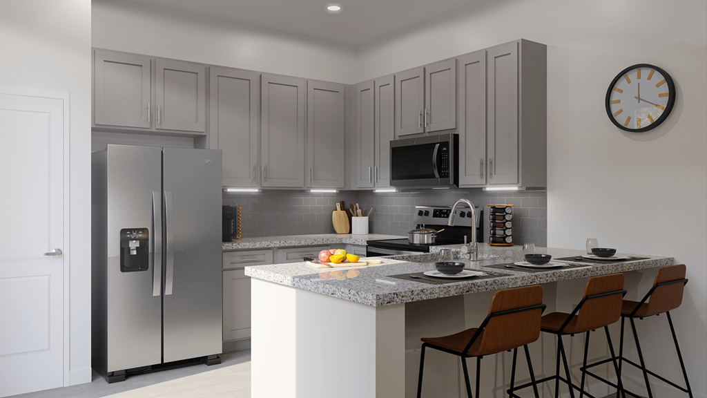 a kitchen with stainless steel appliances and a marble counter top