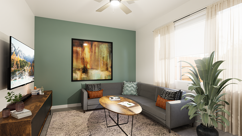 a living room with green walls and a gray couch and a coffee table
