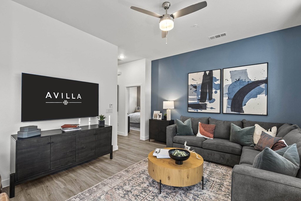 Modern Living Room at Avilla Railhead, Cleburne, TX 76033A living room with a couch, a coffee table, and a painting on the wall.