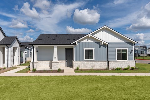 A house with a grey front and white trim.
