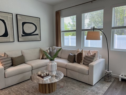 A living room with two couches, a coffee table, and two framed pictures on the wall.