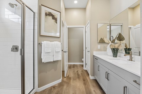 A bathroom with a white sink and a mirror.