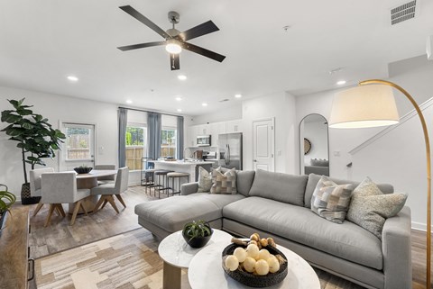A modern living room with a grey sofa and a wooden coffee table.