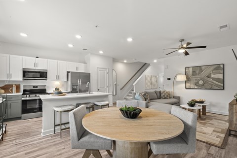 A modern kitchen with a dining table and chairs.