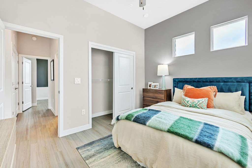 a bedroom with a bed and a closet at Avilla Towne Center Apartments, Texas
