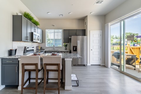 A kitchen with a bar stool and a counter.