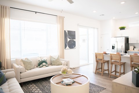 A modern living room with a white couch and a coffee table.