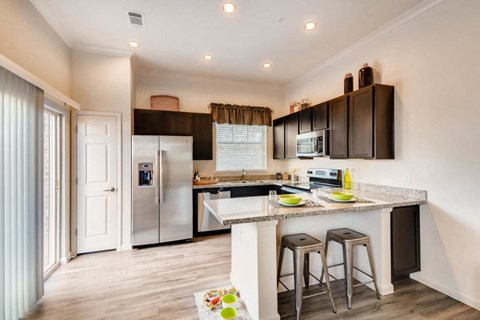 a kitchen with a counter top and a refrigerator